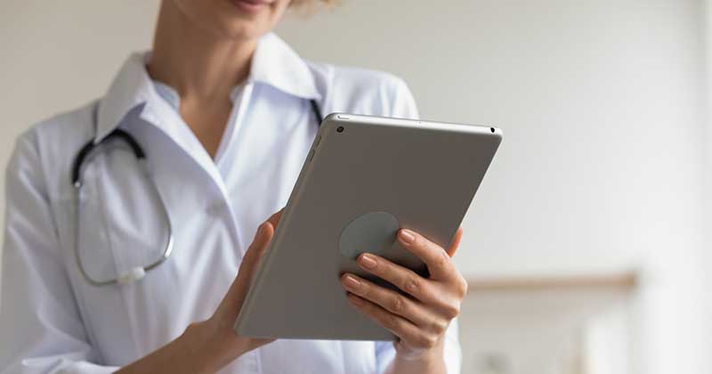 doctor using iPad EHR