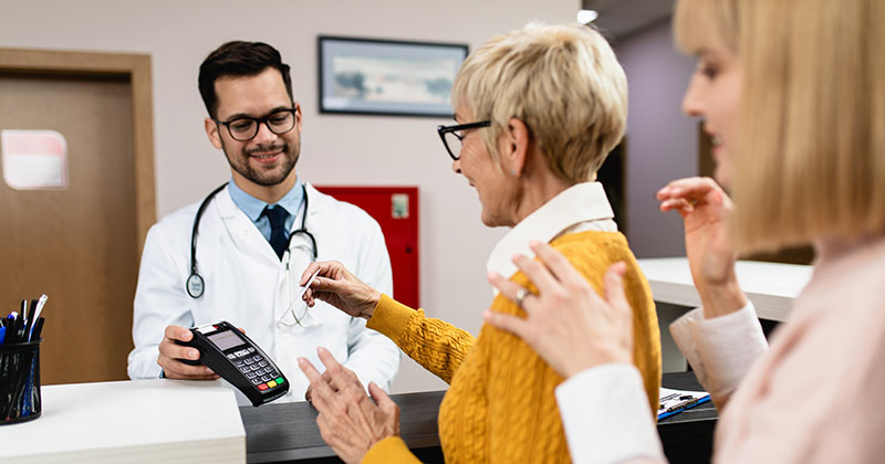 Doctor writing on clipboard