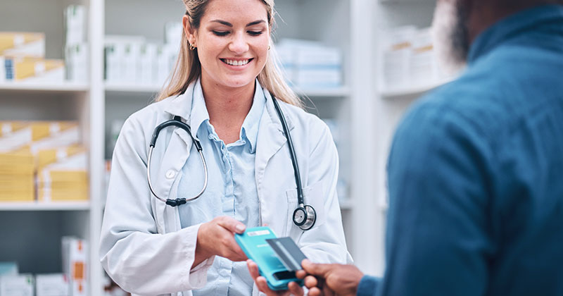 Doctor taking patient credit card payment