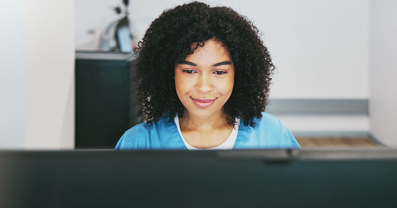 Medical worker using computer at desk