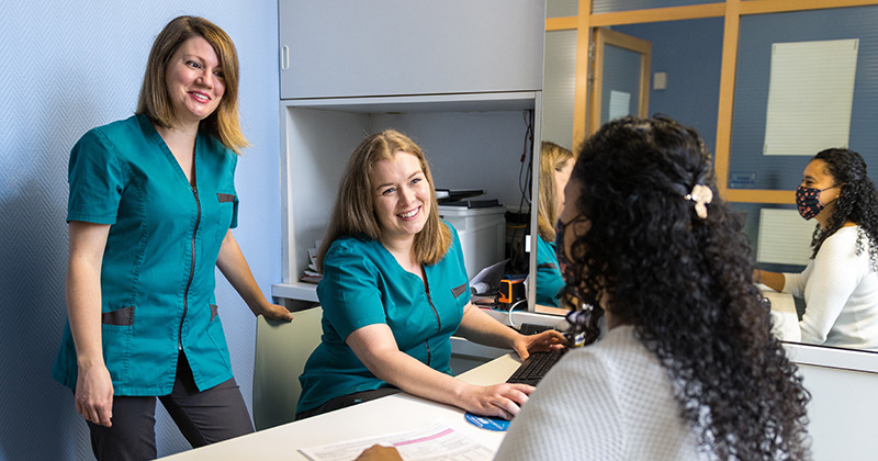 E3 - Nurses interact with a patient at check-in.