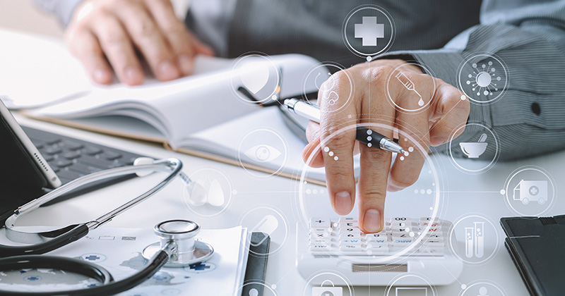 C4 - Doctor using a calculator.