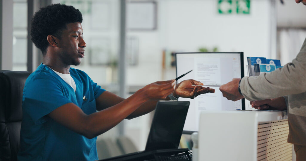 Man, nurse or receptionist with paperwork for consent form or medical appointment document. Male person, clinic secretary or health assistant with pen at front desk for patient visit or schedule.