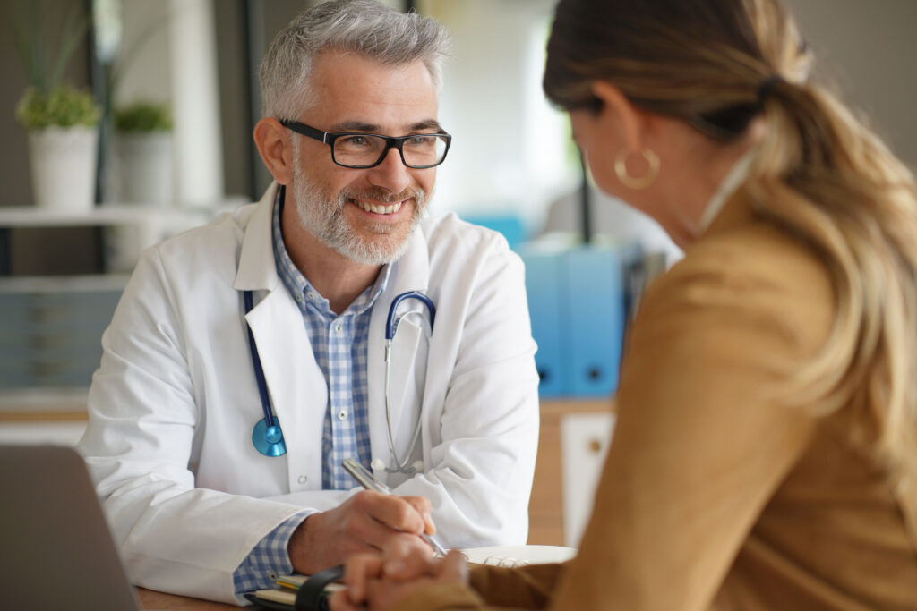 Woman having medical appointment with doctor in hospital