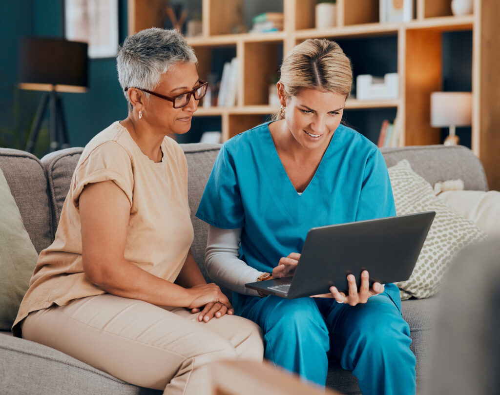 Home visit, woman and doctor with laptop on sofa checking medical results or chart online. Healthcare, technology and nurse or caregiver help consulting with patient on computer on living room couch