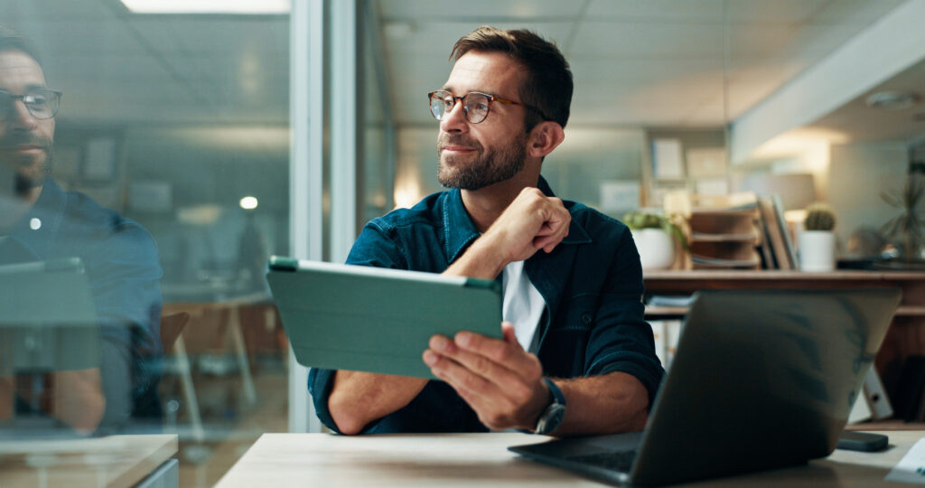 How AI Scribe Software Helps Reduce Coding Errors Tablet, thinking and smile with business man in office for planning, ui designer and app review. Developer solutions, reflection and research with person in agency for project idea and startup.