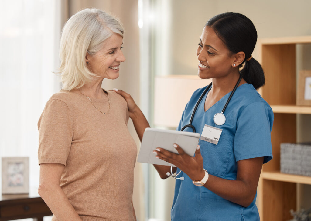 How Unified Messaging Improves Clinical Communication Shot of a doctor using a digital tablet during a consultation with a senior woman at home