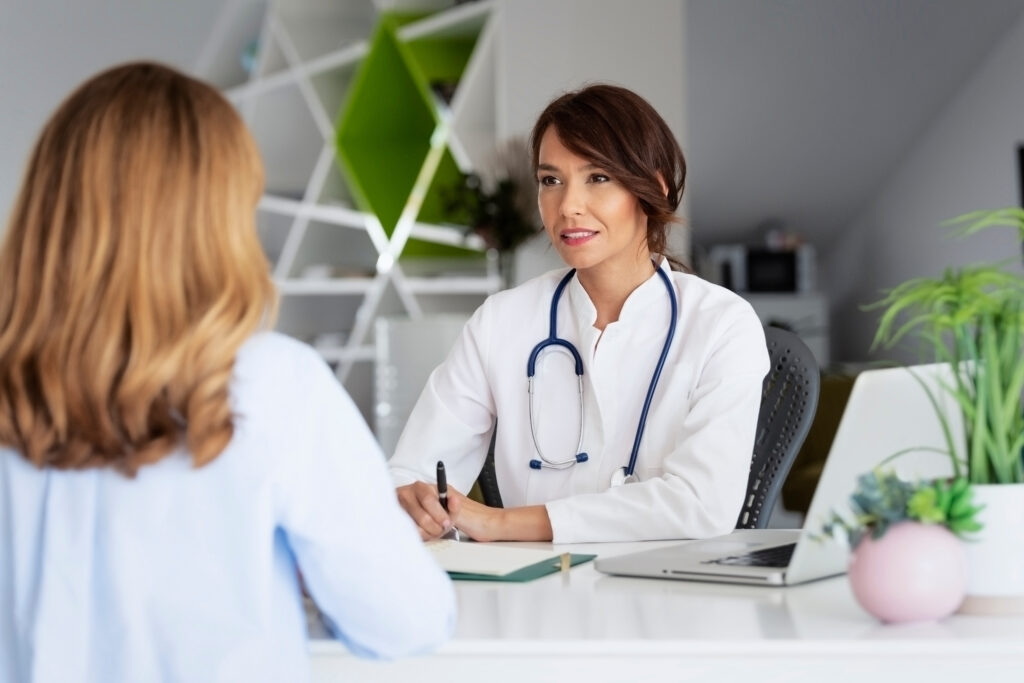 The Impact of Small Front-End Errors on the Revenue Cycle Female doctor working in the office and listening to the patient while she is explaining her symptoms and consulting.