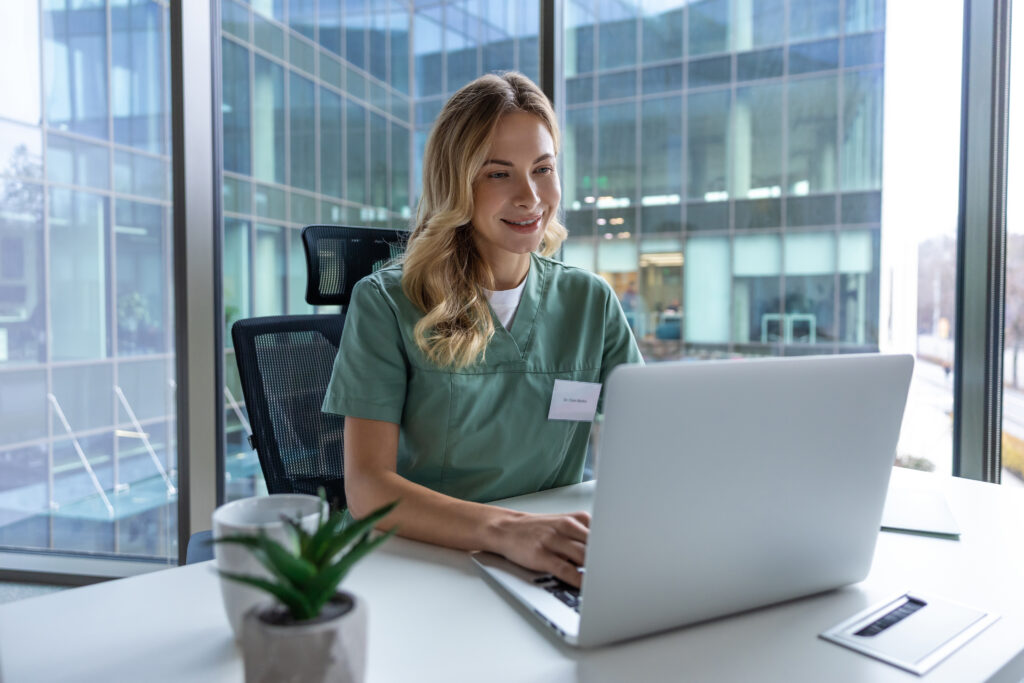 How Fax Automation Reduces Front-Office Administrative Work Woman medical specialist in clinic using computer analyzing patient case histories organizing paperwork