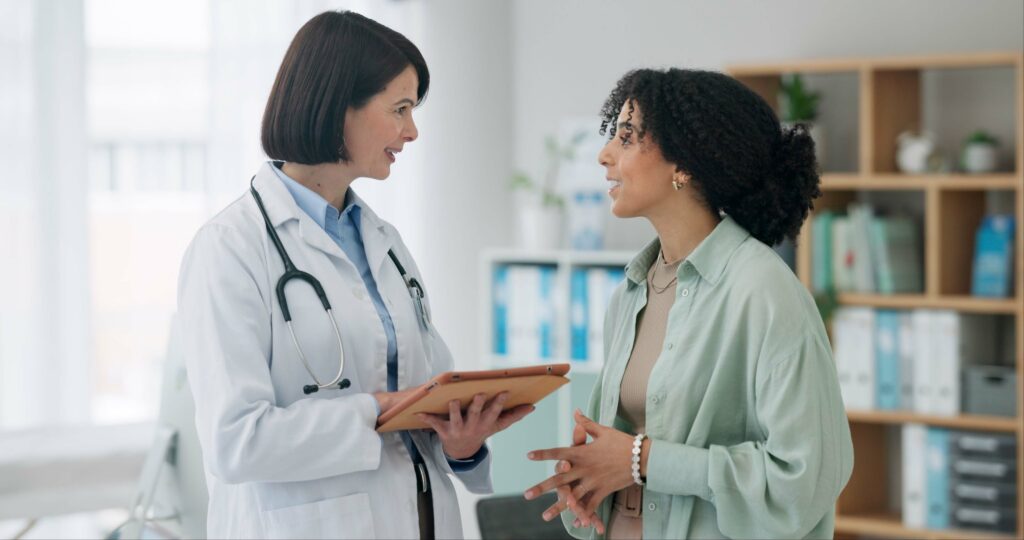 Healthcare Technology Challenges For Independent Practices Hospital, tablet and doctor with patient for consulting, medical service and help in clinic. Healthcare, telehealth and worker with woman on digital tech for diagnosis, online results and insurance.
