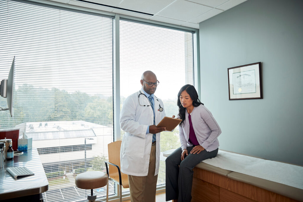 Why Front-End Patient Communication Impacts Operational Efficiency Doctor speaking with female patient
